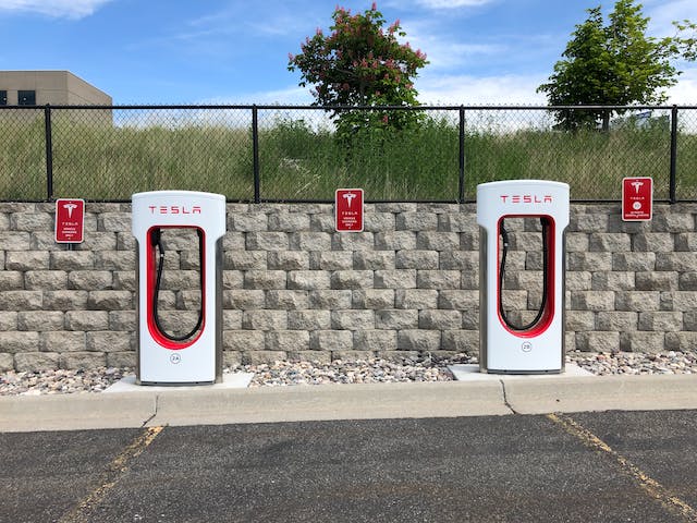 two red and white Tesla charging stations.