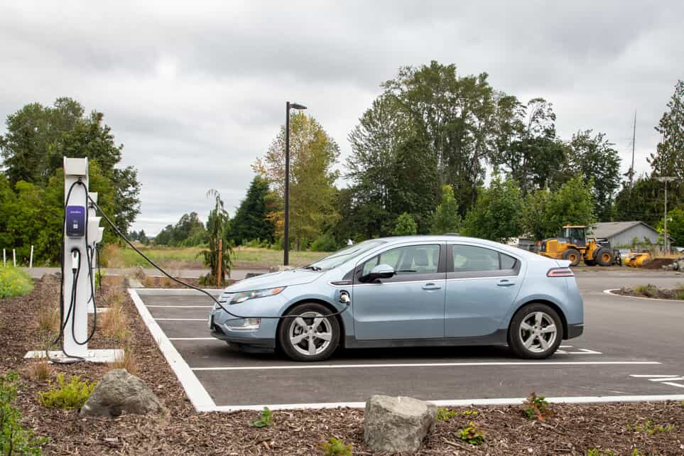 a silver car plugged into a public ev charging station