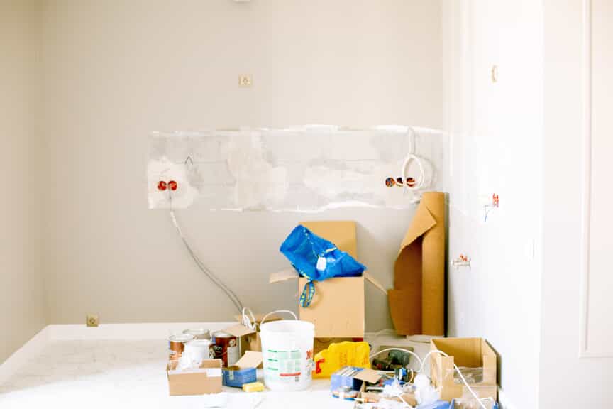 room being renovated with materials all over the floor and electrical with coming out of the wall