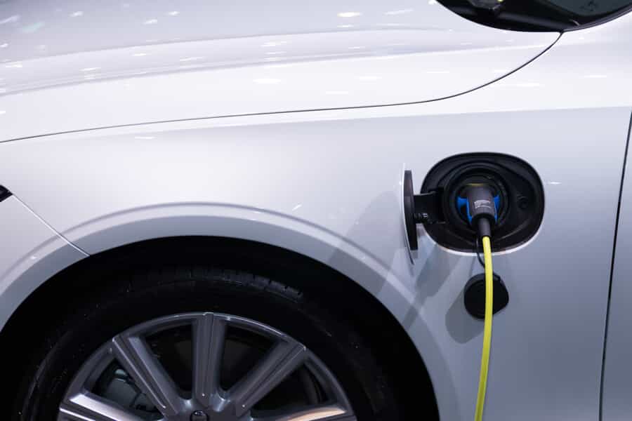 : a close up of a white electric car charging